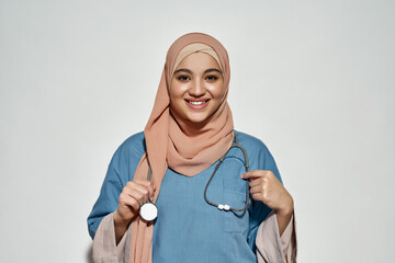 Cheerful young arabian woman in doctor outfit