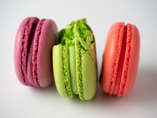 bright colorful delicious almond cookies on a white background. One of them is bitten off. Side view