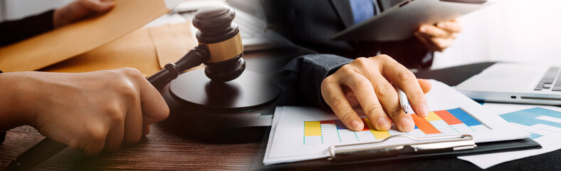 Justice and law concept.Male judge in a courtroom with the gavel, working with, computer and...