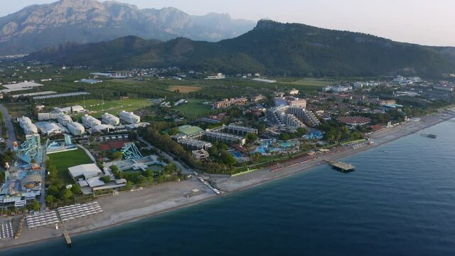 Drone fly over resorts in Kiris. Coastline with luxury hotels with pools and umbrellas on the beach in Kemer, Turkey