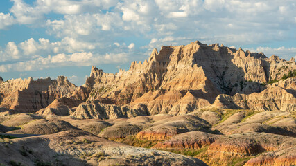 Yellow mounds and colorful red rocks and dramatic mountains in the Badlands National Park - South...