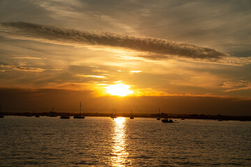 Sunset in cloudy day on Sandbanks beach United Kingdom looks beautiful ,sky was covered with nice golden colours