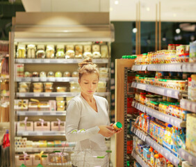 Woman choosing a dairy products at supermarket