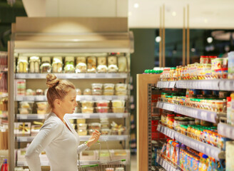 Woman choosing a dairy products at supermarket