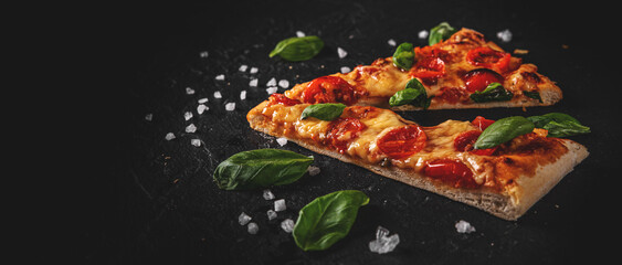 two slice of flatbread Pizza with Mozzarella cheese, Tomatoes, pepper, Spices and Fresh Basil....