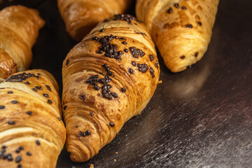Croissants with chocolate on a baking sheet.