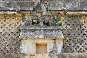 Closeup view on the ancient mayan building and bas reliefs on the wall on the Uxmal archeological site, Mayan city, representative of the Puuc architectural style, Yucatan, Mexico
