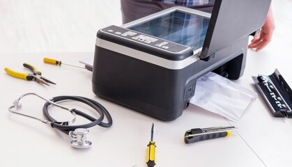 Repairman repairing broken color printer