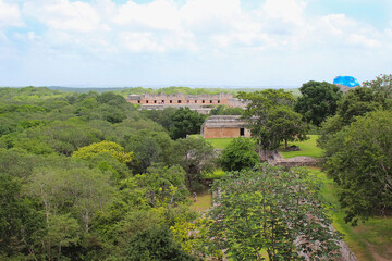 Fototapeta na wymiar Uxmal, aerial view on Nunnery and the Pyramid of the Magician, view from the top of Great Pyramid situated on the territory of Uxmal archeological and historical site, Yucatan, Mexico. Soft focus