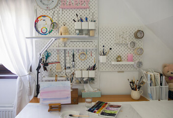 workplace of illustrator artist, lamp, brushes on work board