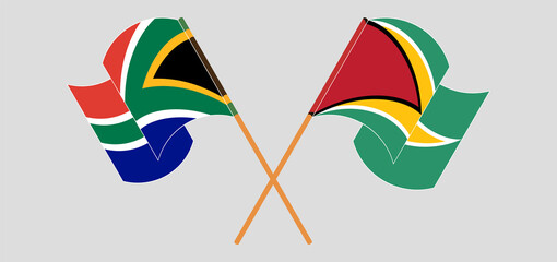 Crossed and waving flags of Republic of South Africa and Guyana.