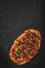 flatbread Pepperoni Pizza with Mozzarella cheese, salami, Tomato sauce, pepper, Spices. Italian pizza on Dark grey black slate background