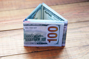 Money in cash in in triangular shape. Hundred dollar notes