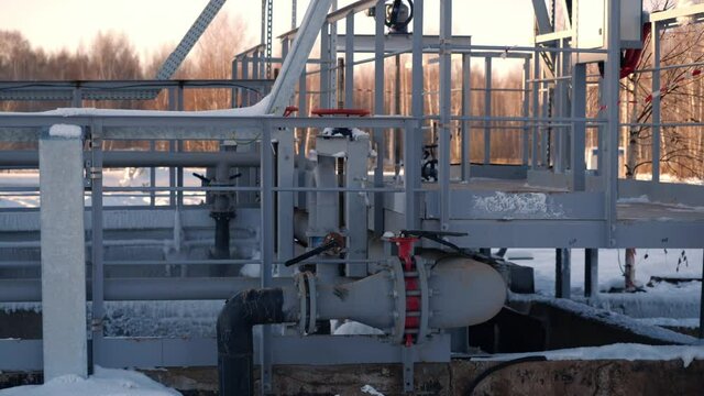 Compressor with pipe near technical ground at contemporary wastewater treatment plant in cold winter evening closeup