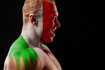Italy fan. Soccer or football athlete with flag bodyart on face. Sport concept with copyspace.