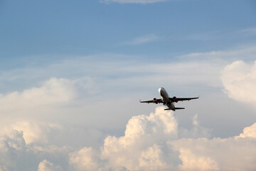 Plane taking off from the runway, flying through the clouds, increasing its height
