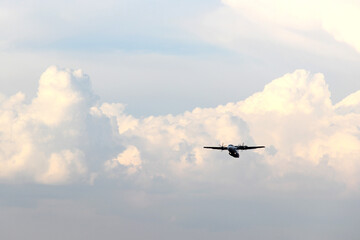 Plane taking off from the runway, flying through the clouds, increasing its height
