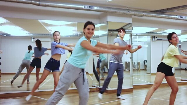 Group of teenage boys and girls enjoying dance class together