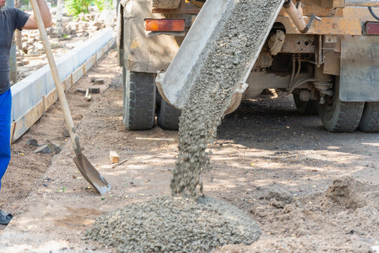 Unloading cement from the mixer.