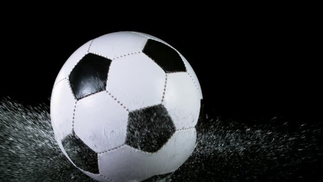 Close-up Foot Falling Soccer Ball into Water, Super Slow Motion at 1000 fps. Filmed on high speed cinematic camera.