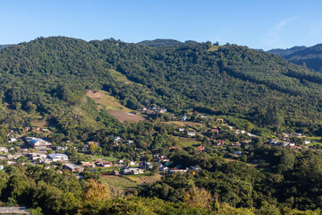 Village around forest and mountains