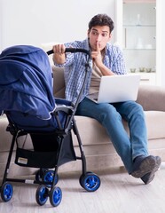 Young father looking after newborn baby at home