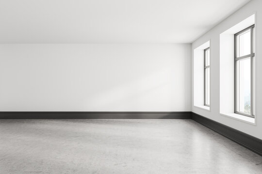 Empty white room interior with gray floor and two windows