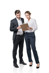 Full length of businesswoman and businessman in formal wears is holding and pensive looking into clipboard with papers or contract. Business people Isolated over white background. Concept of teamwork