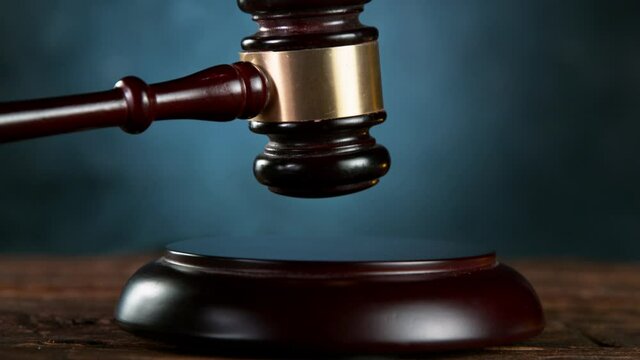 Super slow motion of gavel being struck to decide an auction or guilty verdict in court. Filmed on high speed cinematic camera.