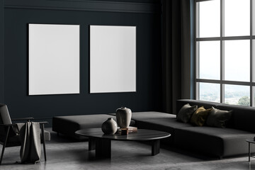 Two framed mockup posters in villa living room design interior, grey furniture on blue wall, cement floor. Concept of relax. Panoramic window.