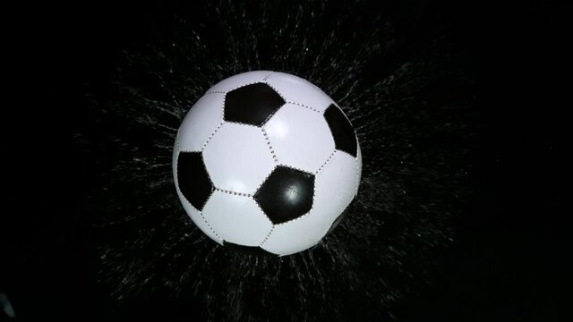 Close-up Foot Falling Soccer Ball into Water, Super Slow Motion at 1000 fps. Filmed on high speed cinematic camera.