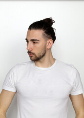 Attractive male model with long hair and beard posing in studio on isolated background. Style, trends, fashion concept.