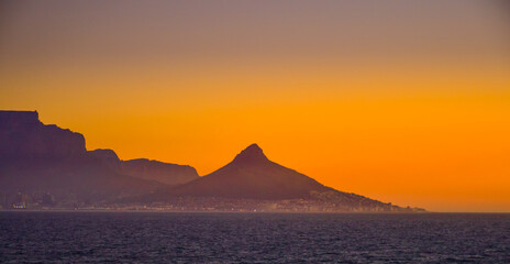 Naklejka na ściany i meble Lion's head, Table mountain and signal hill at sunset in cape town