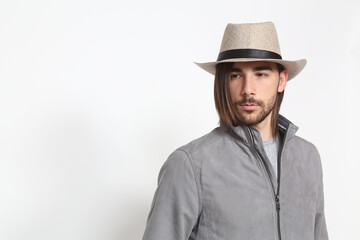 Attractive male model with long hair and beard posing in studio on isolated background. Style, trends, fashion concept.