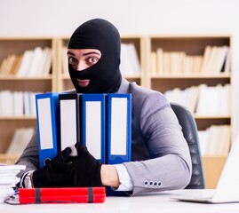 Criminal businessman with balaclava with dynamite