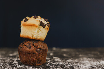 Homemade chocolate chips and vanilla muffin on a black background with sugar