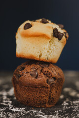 Homemade chocolate chips and vanilla muffin on a black background with sugar