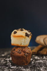 Homemade chocolate chips and vanilla muffin on a black background with sugar