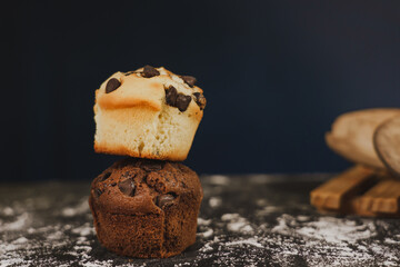 Homemade chocolate chips and vanilla muffin on a black background with sugar