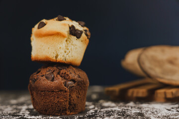 Homemade chocolate chips and vanilla muffin on a black background with sugar