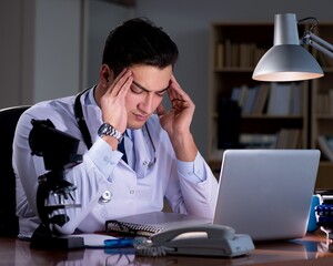 Young doctor working late in the office