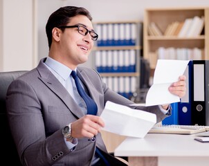 Businessman receiving letter envelope in office