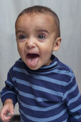 portrait of boy expressing euphoria and anger