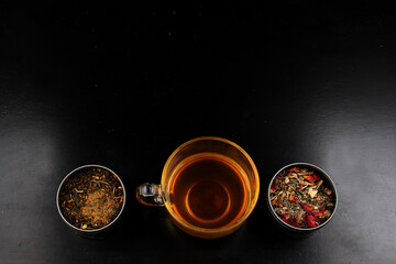 Tools for the preparation of herbal tea: glass cup, infuser, spoon, dehydrated, dried herb and sachets
