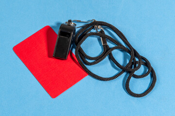 Red card and referee whistle with space for text