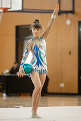 young teen girl doing rhythmic gymnastics