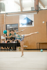 young teen girl doing rhythmic gymnastics