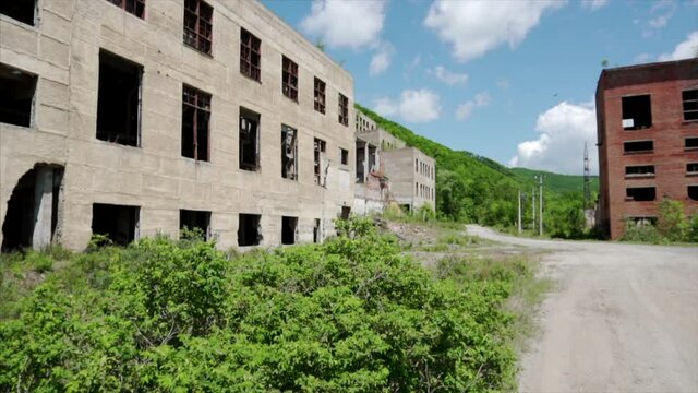 Khrustalnensky mining and processing plant. The camera pans past the ruined, abandoned workshops of an old factory.