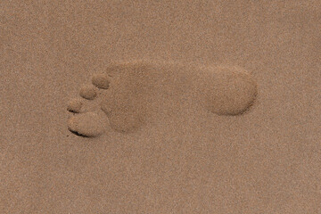 Fototapeta na wymiar Beach sand footprint. Tropical travel, summer vacation holiday paradise background template. Human steps on shore.