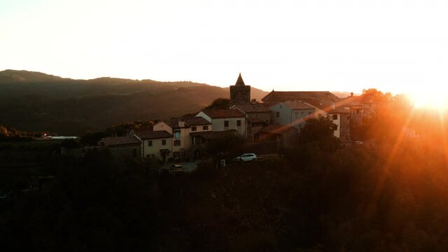 Golden Sunlight Shining Over Houses And Hum Bell Tower In Hum At Buzet, Istria, Croatia. - aerial orbit